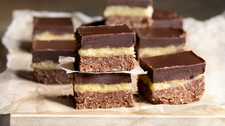 Dark chocolate ginger slice arranged on a sheet of baking paper