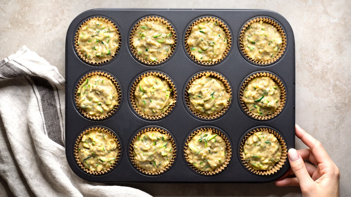 Divide the batter between the muffin cases