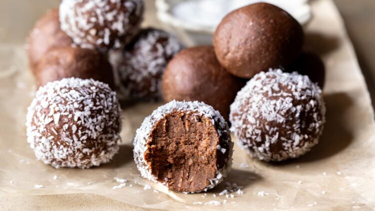 Chocolate mint protein balls with a bite taken out of one ball