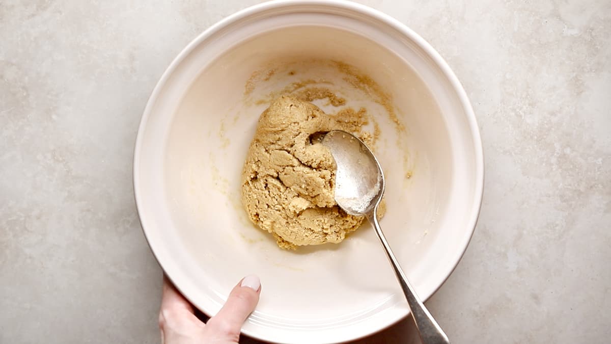 Sticky protein bar dough mixed in a bowl with a spoon