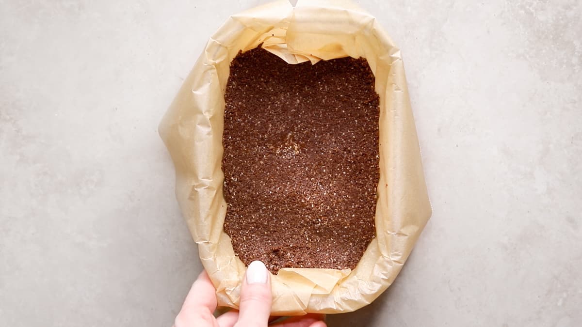 Chocolate biscuit base pressed into a container