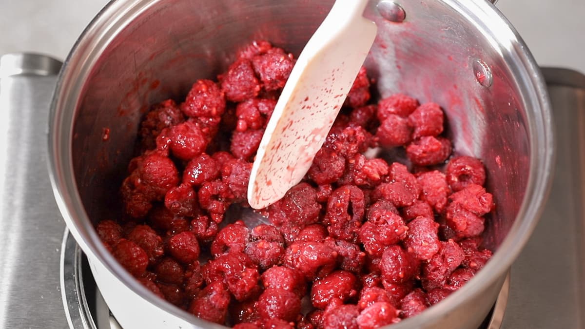 Frozen raspberries cooking in a saucepan