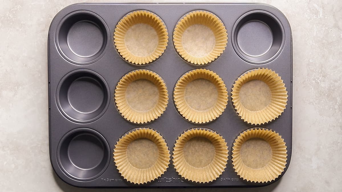 Line a muffin tray with paper muffin cases