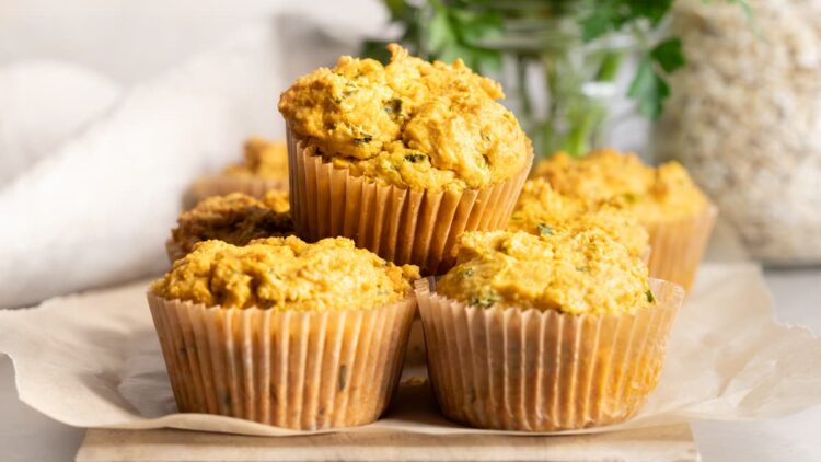 Savory sweet potato muffins with fresh herbs on a wooden board