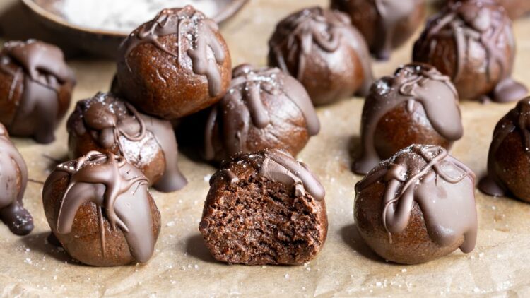 Choc mint whey protein balls arranged on a sheet of baking paper