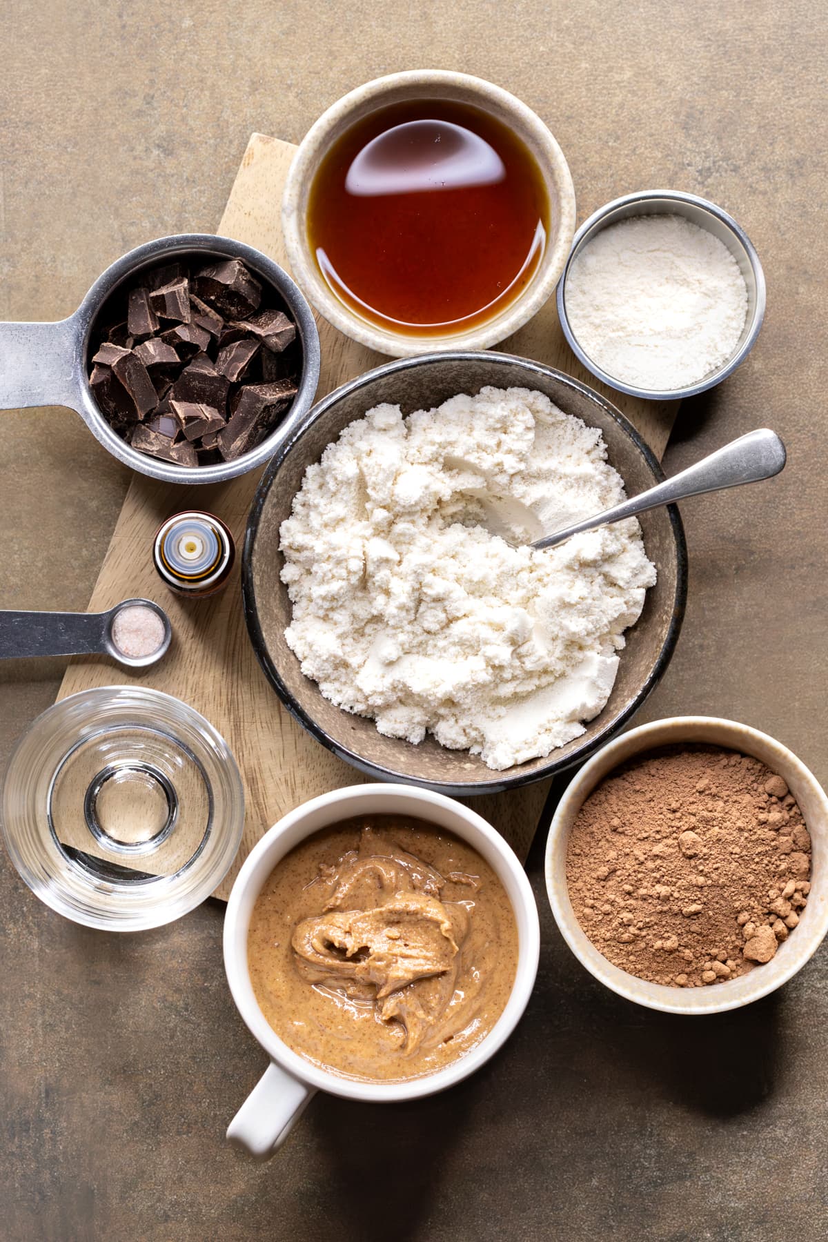 Ingredients for choc mint whey protein balls arranged in bowls and measuring cups