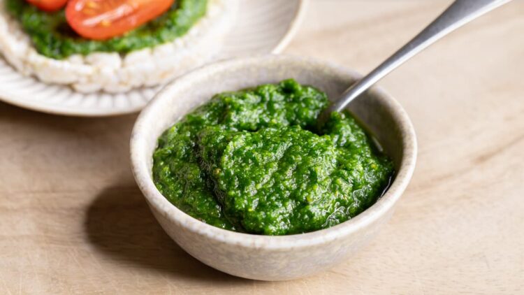 Parsley pine nut pesto in a bowl with a spoon