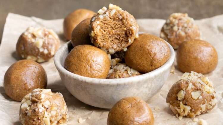 Easy coffee whey protein balls coated with chopped nuts in a bowl