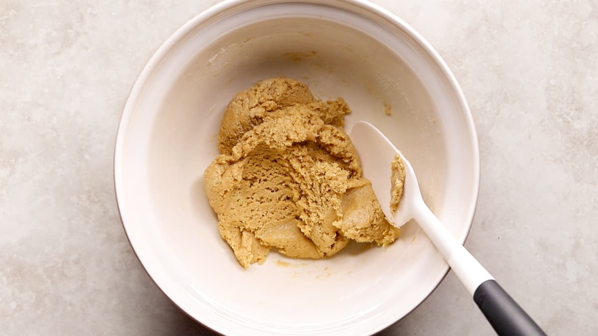 Mixing bowl with cookie dough protein bar mixture containing collagen powder and coconut flour