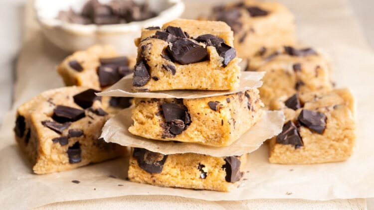 Collagen powder cookie dough protein bars separated by sheets of baking paper