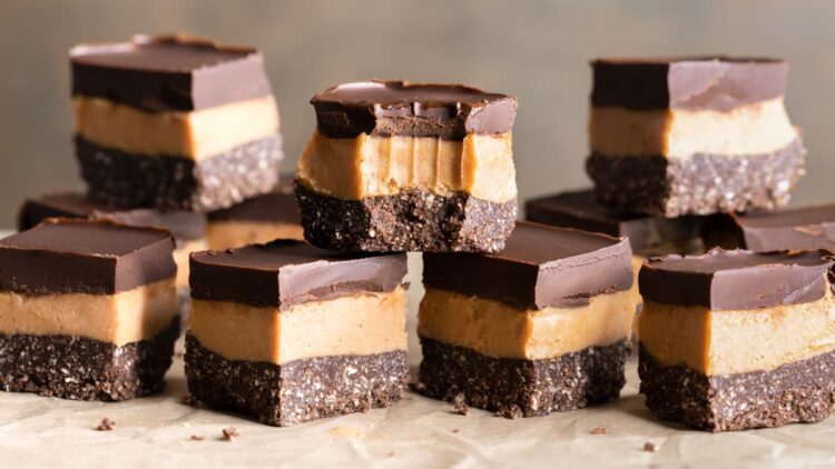 Pieces of easy no-bake vegan slice stacked on top of each other