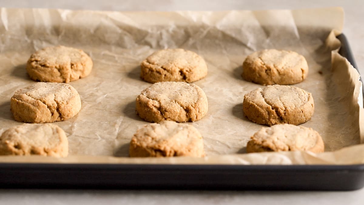 Baked almond olive oil shortbread cookies cooling on a lined baking tray