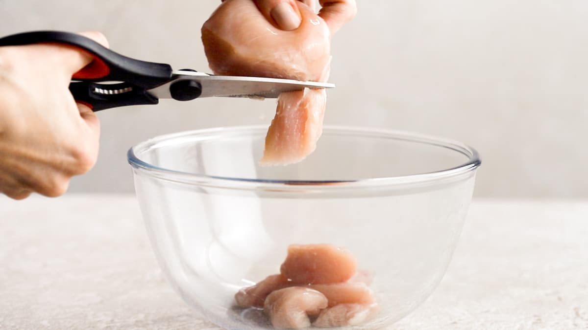 Cut the chicken for the stir fry into bite-sized pieces