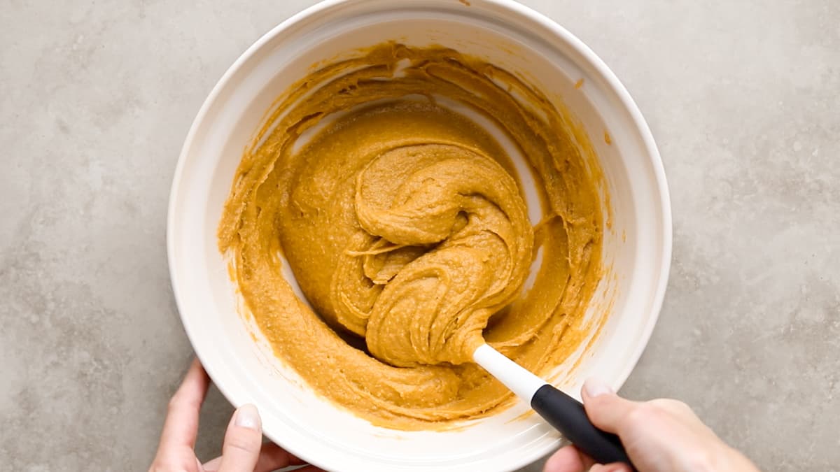 Smooth pumpkin bread batter in a mixing bowl, ready to pour into the loaf pan