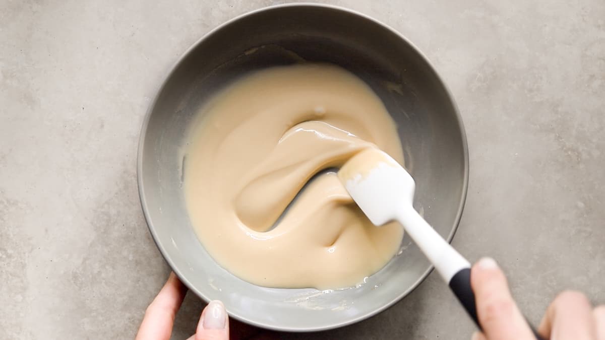 Small bowl of smooth maple glaze being mixed