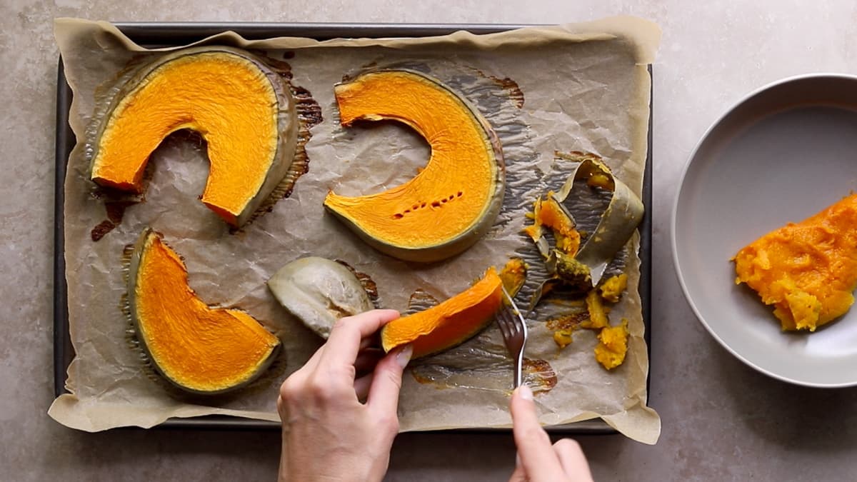 Removing the skin off baked pumpkin
