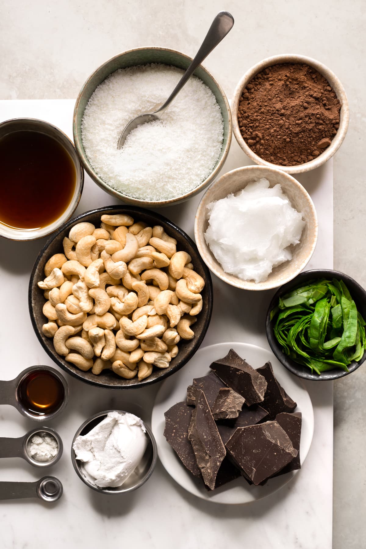 Ingredients for vegan no-bake chocolate mint slice set out on a marble tray