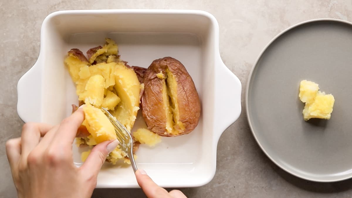 Baked red potato with skin on, cooked until soft inside