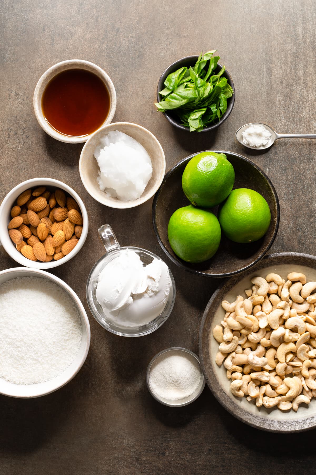 Ingredients for no-bake vegan lime cheesecake arranged in bowls