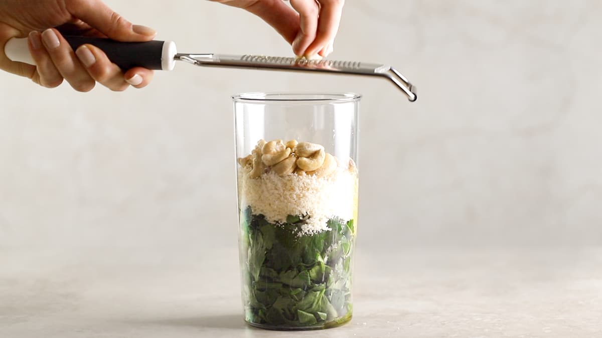 Place all pesto ingredients into a hand blender cup