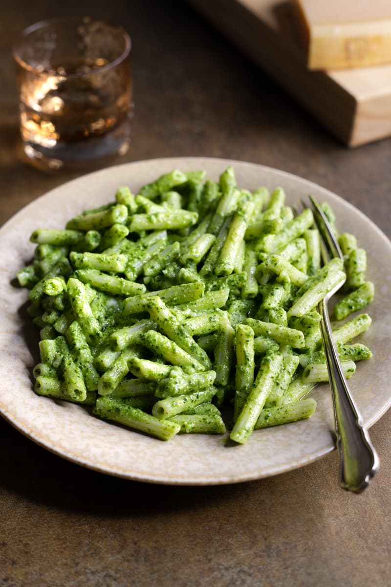 Parsley pesto pasta with cashew nuts served in a bowl