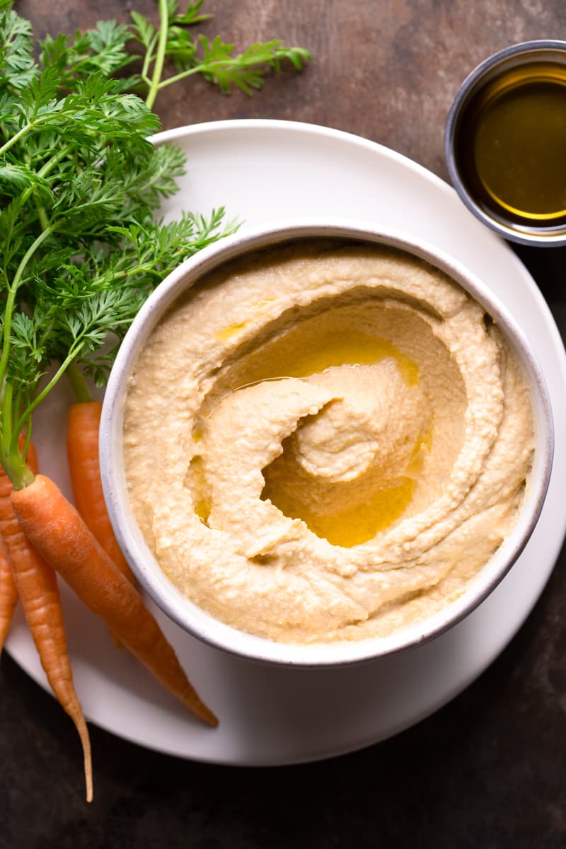 Easy Hummus without Lemon and Garlic served with raw carrots