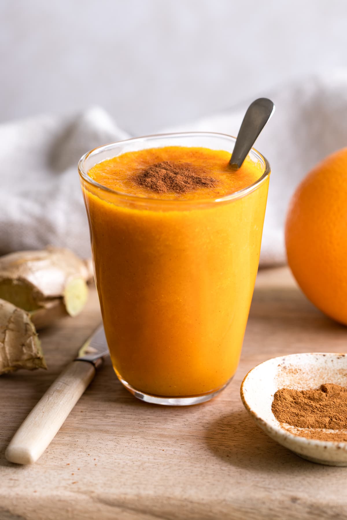 Orange Ginger Carrot Smoothie topped with cinnamon powder