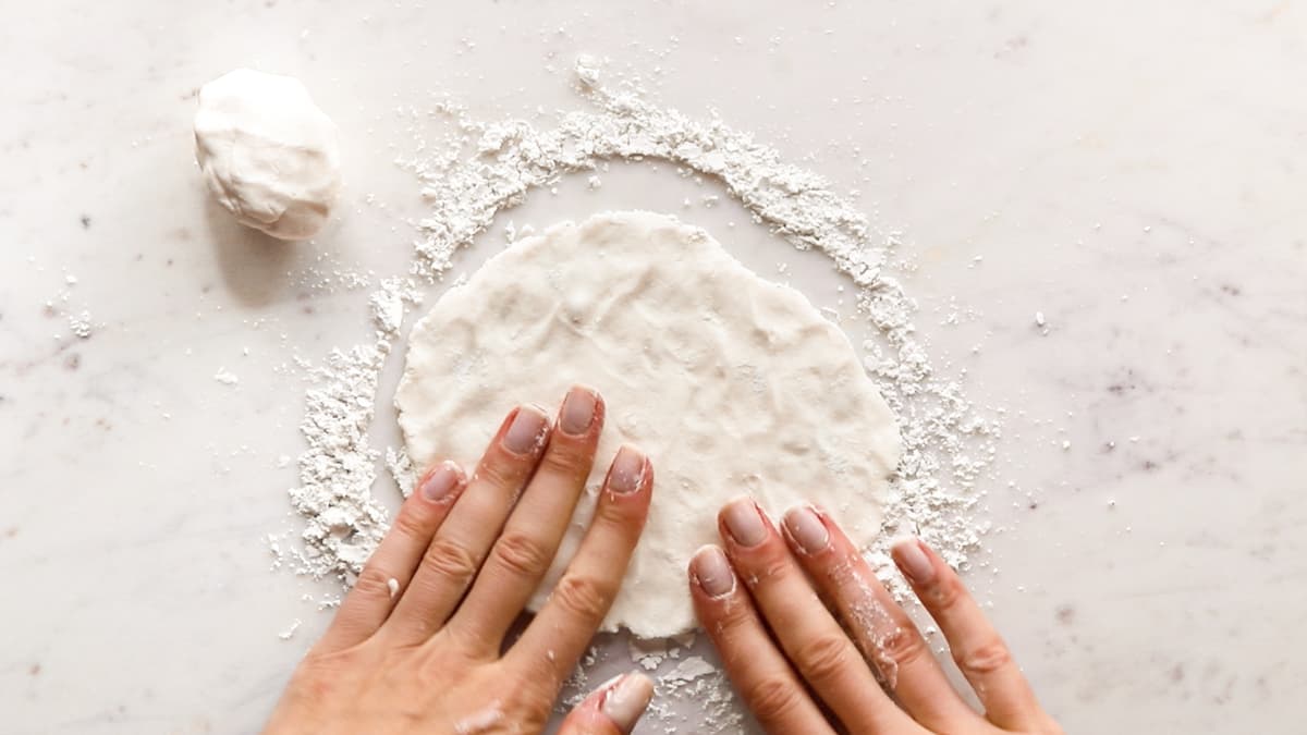 Press the gluten-free dough into rounds to form flatbreads