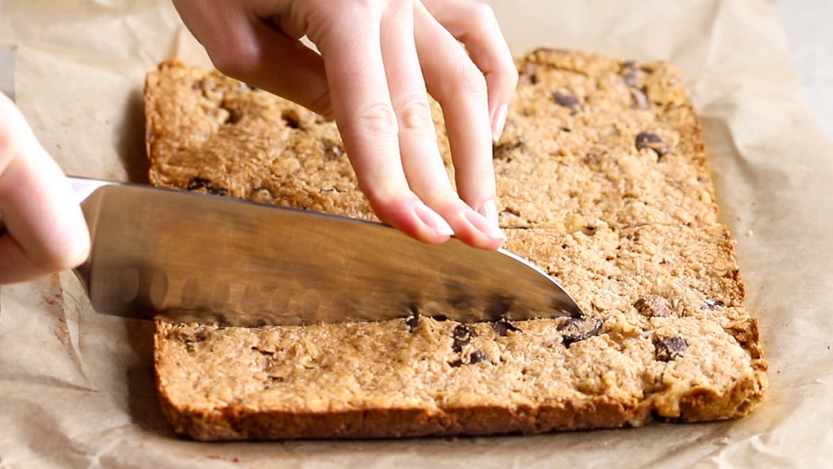 Baked oatmeal breakfast bars being cut into squares