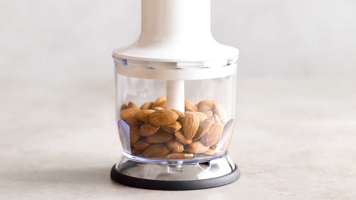 Start the protein bars by blending raw almonds into a flour