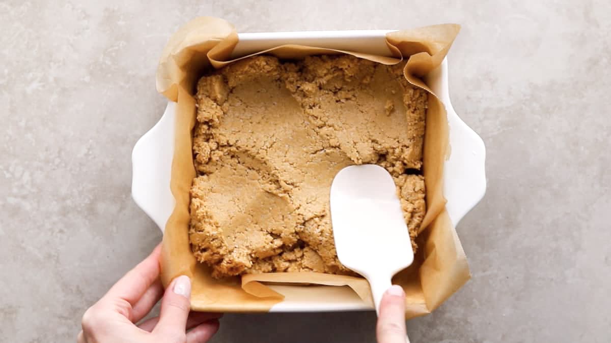 Peanut butter oat protein bar dough pressed in loaf pan
