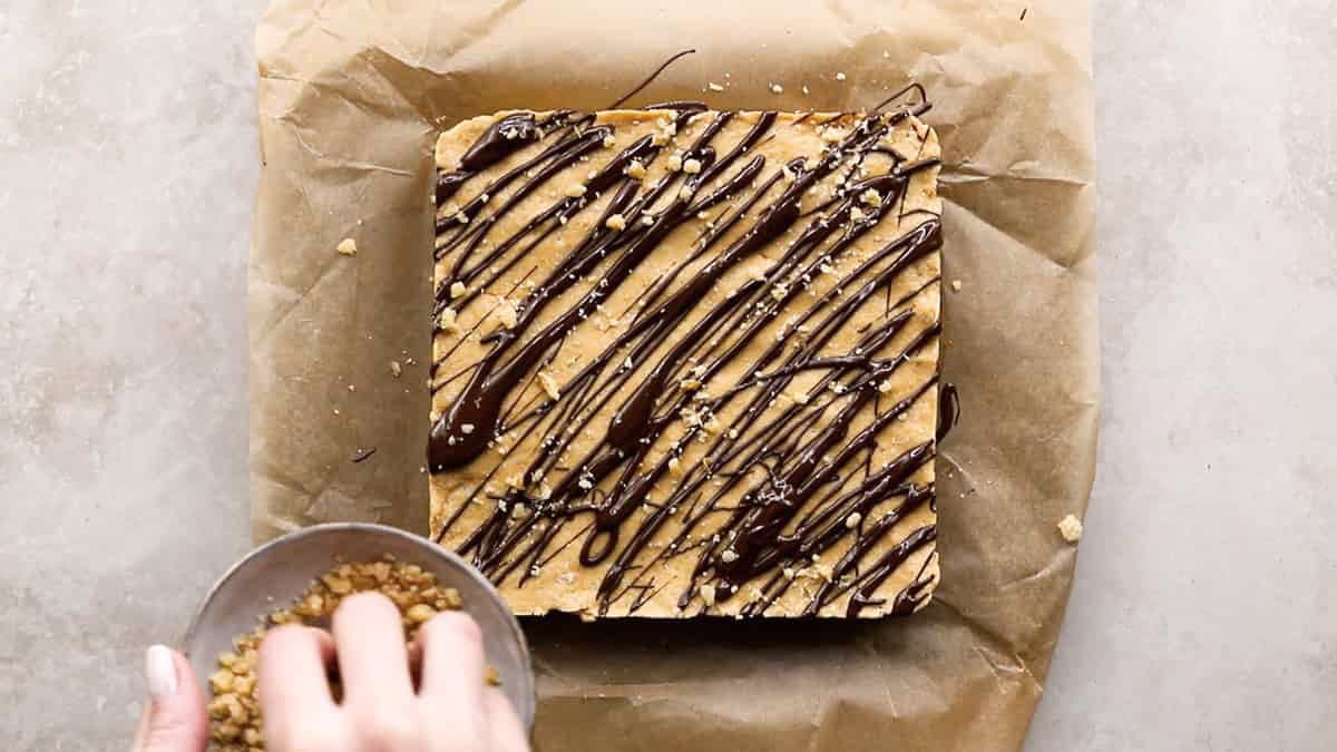Melted chocolate and crushed nuts topping on protein bars