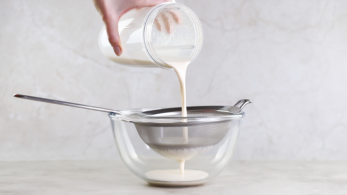 Straining creamy homemade oat milk