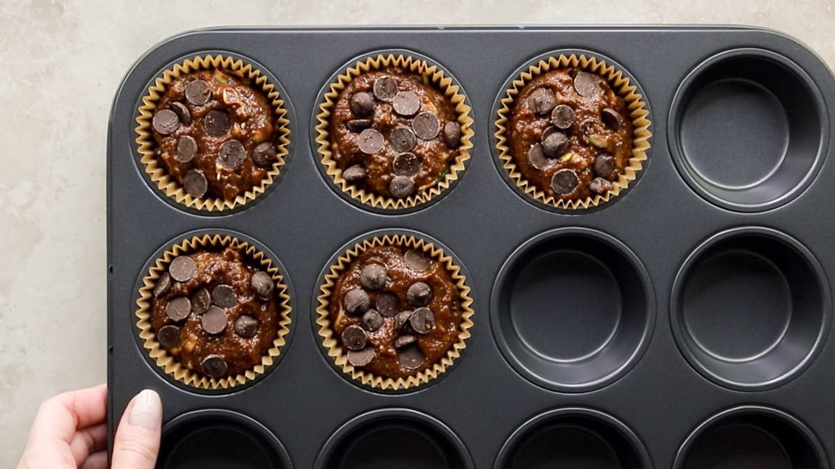 Chocolate zucchini muffin batter in muffin tray