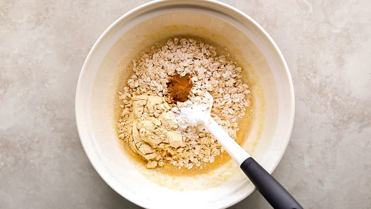 Bowl of banana, cinnamon, oats, protein powder, and other ingredients