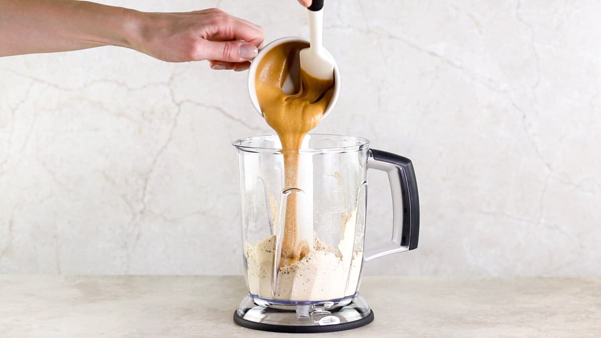 Peanut butter being added into a food processor