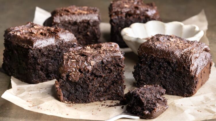 Zucchini brownies with chocolate frosting cut into squares