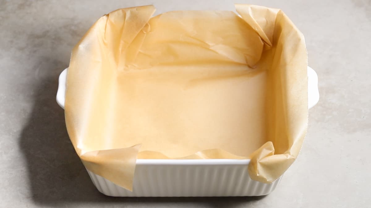 Line a square baking dish with parchment paper