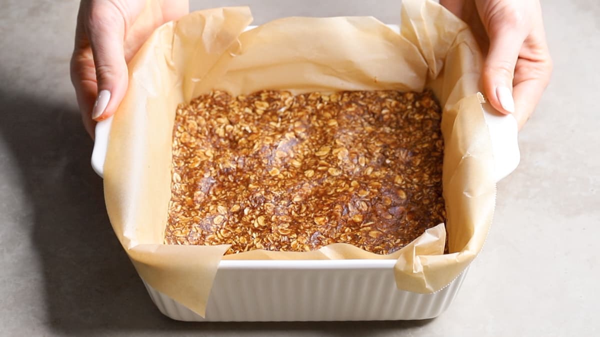 Press two thirds of the oatmeal bar mixture into the baking dish