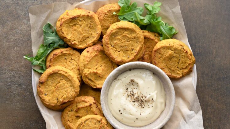 Baked chickpea fritters served with tahini sauce
