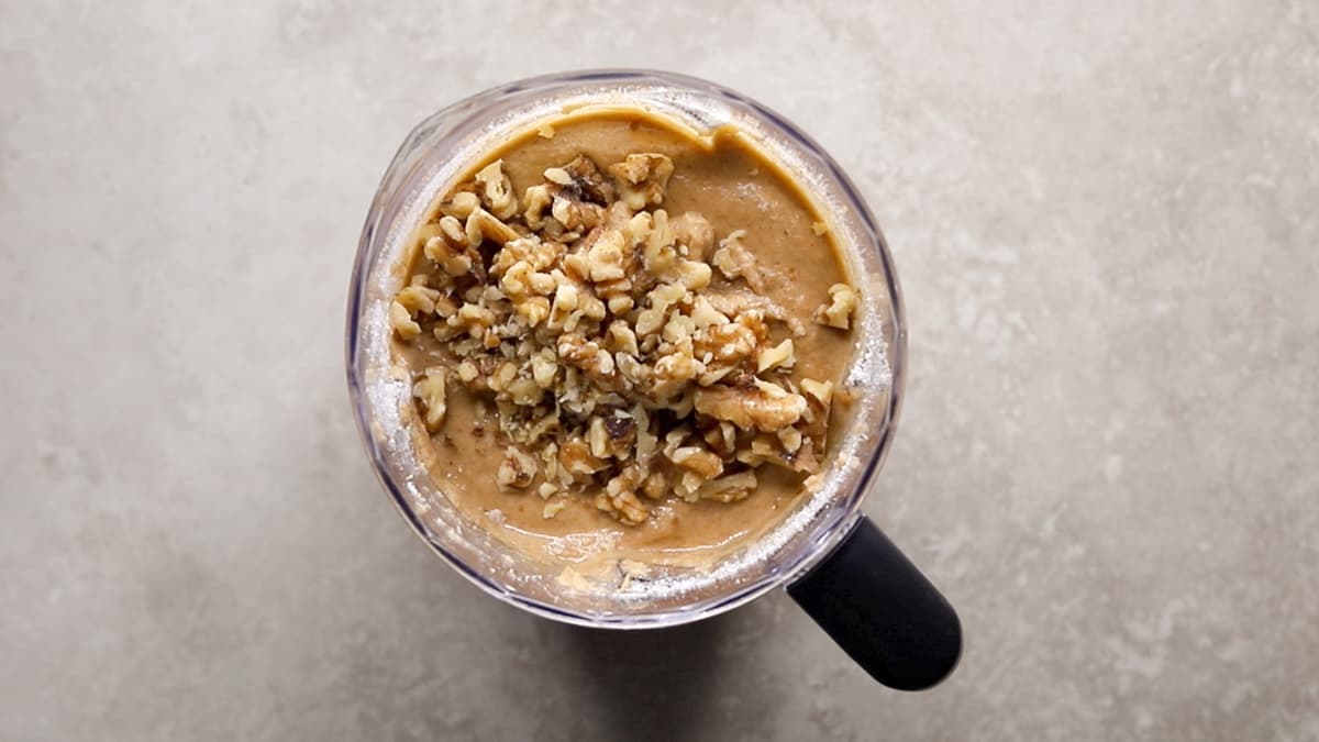 Coconut flour banana bread batter with chopped walnuts mixed in