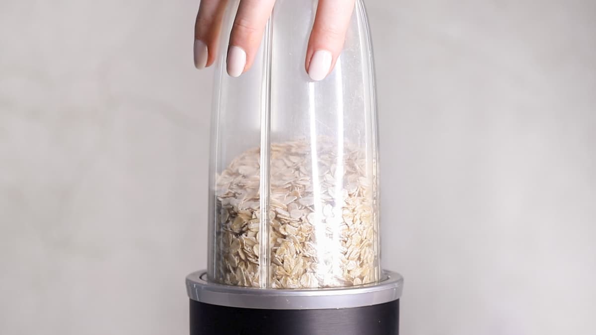 Blend rolled oats in a blender until they form a flour-like consistency