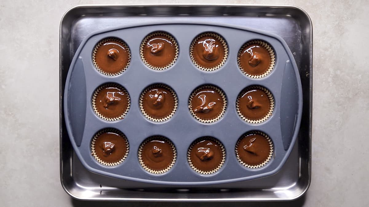 Spoon the chocolate fudge mixture into a mini muffin tray lined with cases