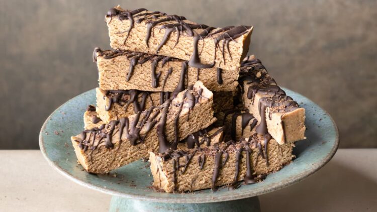 A stack of vegan mint protein bars with chocolate drizzle