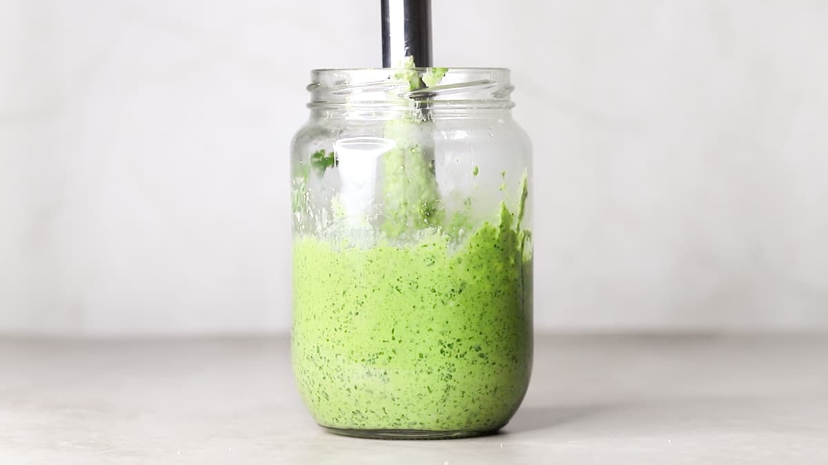 Blend the cashew pesto dressing using a hand blender