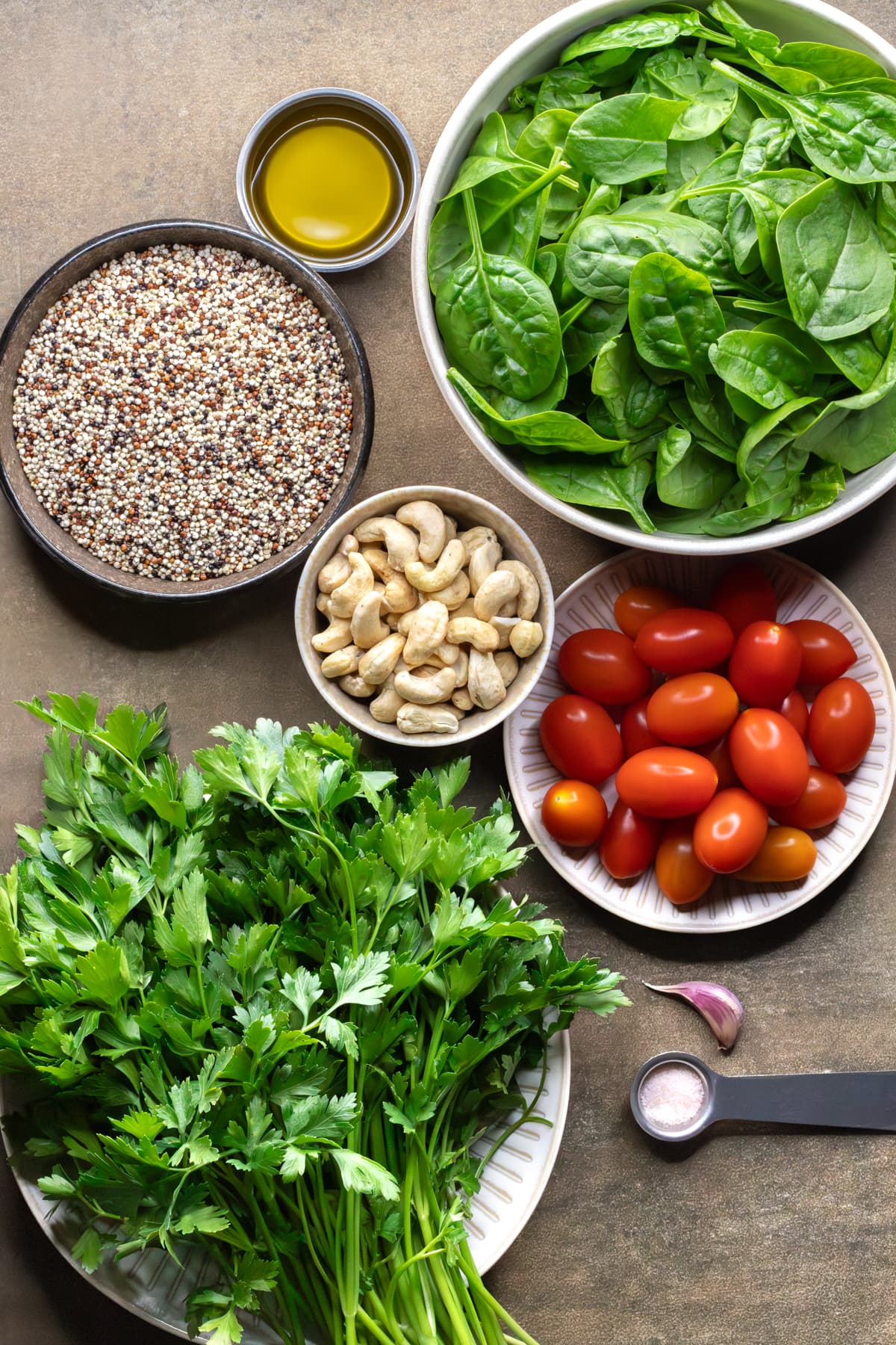A selection of ingredients for chicken quinoa salad with parsley pesto dressing