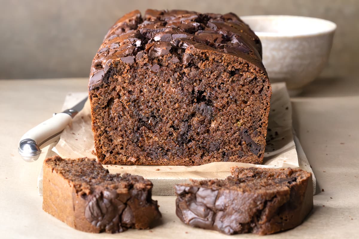 A sliced loaf of zucchini bread with chocolate chips