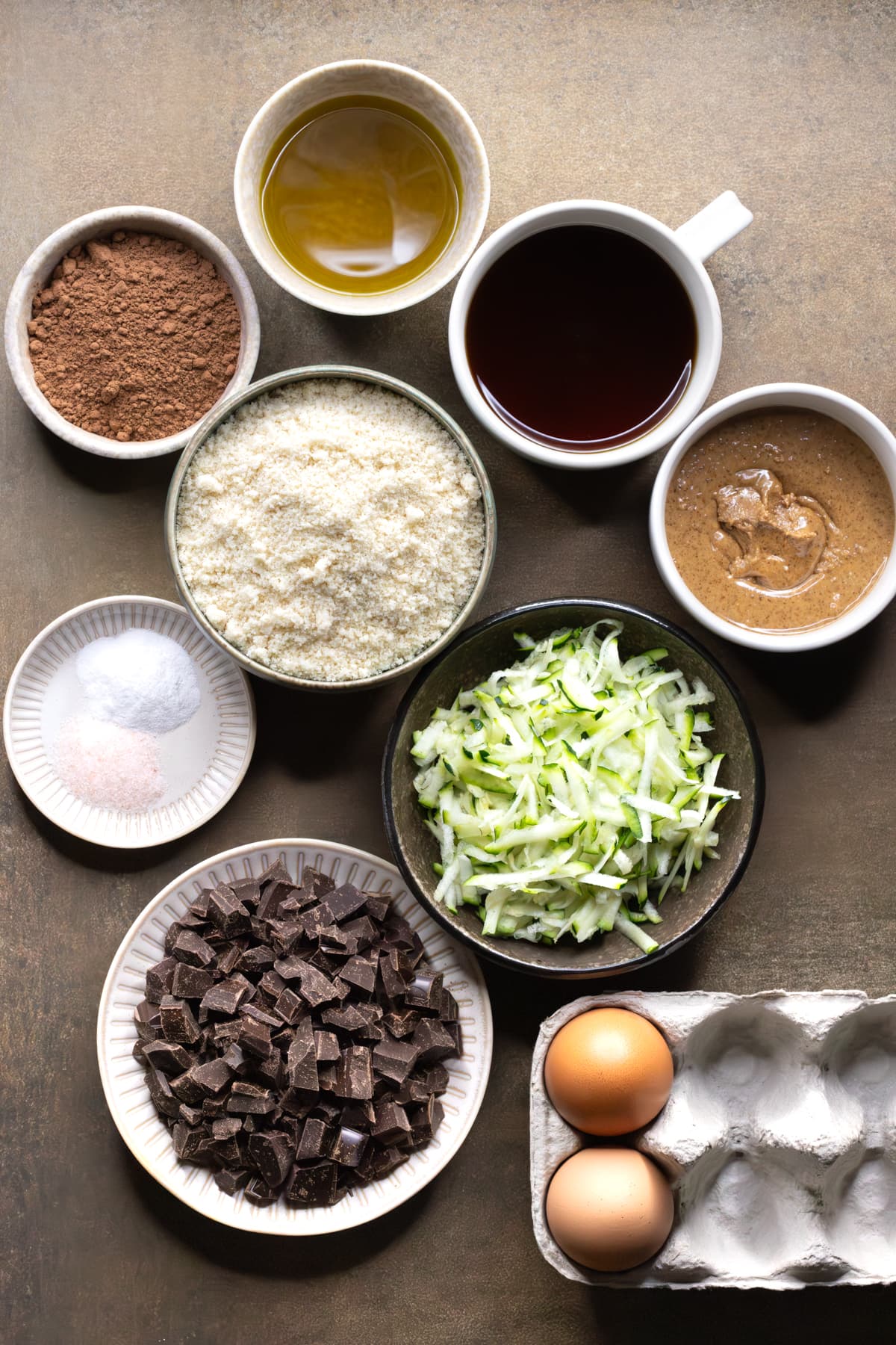 Ingredients for chocolate zucchini bread set out in bowls