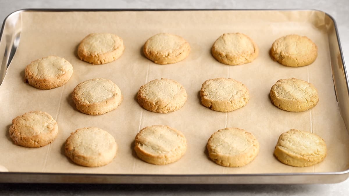 Baked gluten-free lemon shortbread cookies with golden edges on a baking sheet