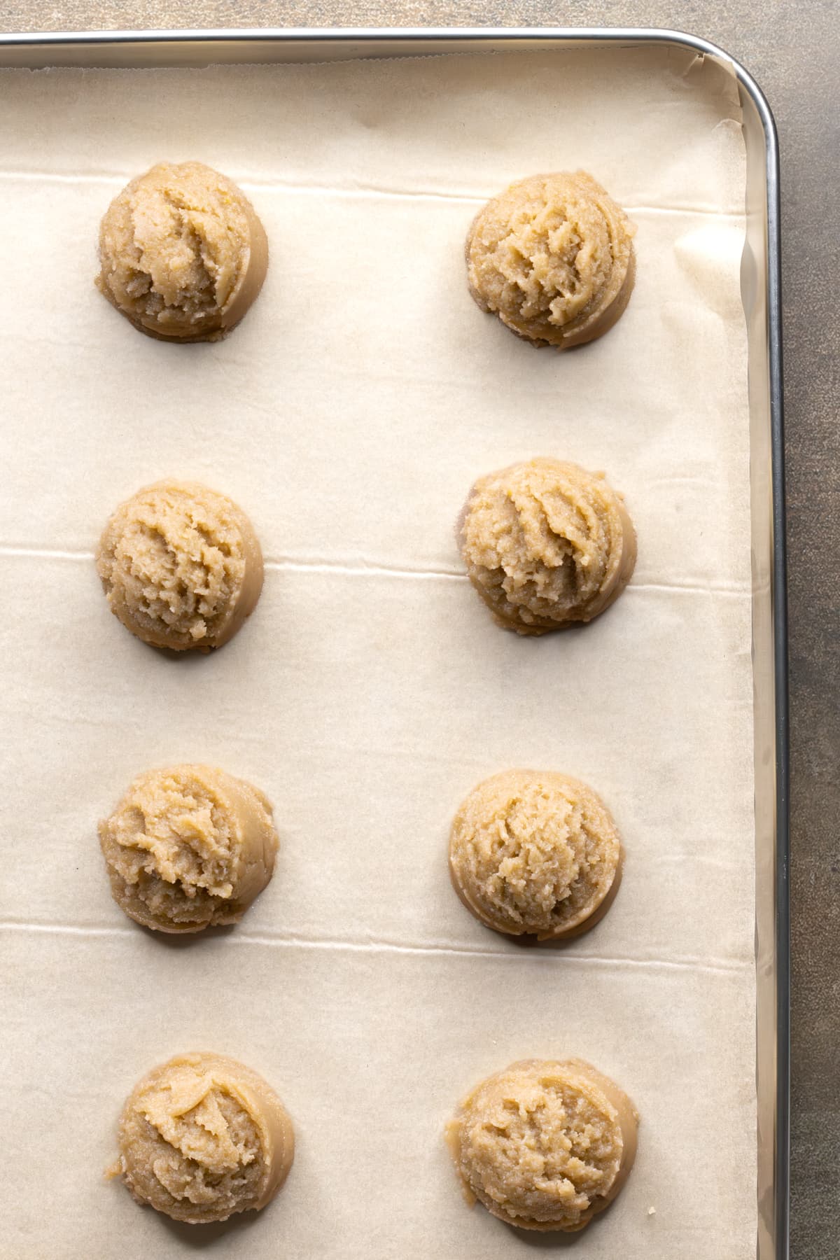 Lemon cookie dough portioned on a baking sheet
